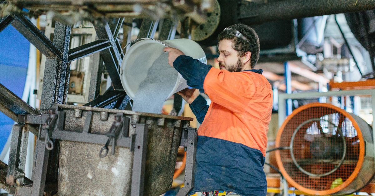 Global Rotomoulding Worker Pouring Poly Mix