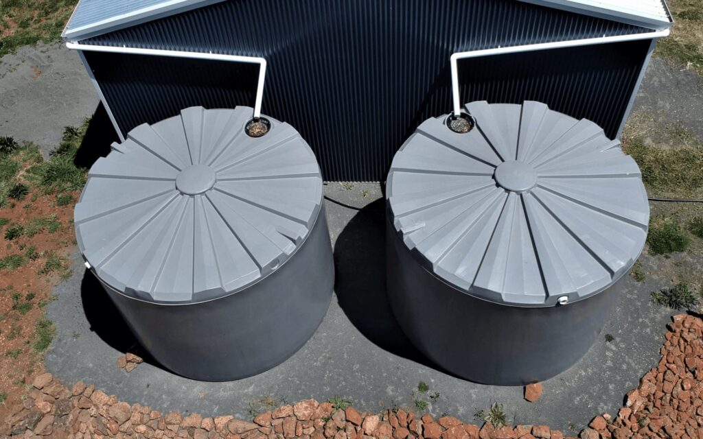 Aerial view of installed water tanks next to an industrial shed