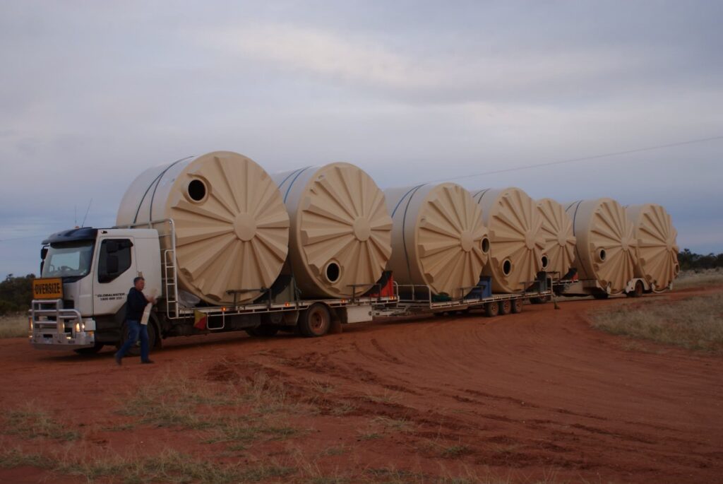 Rainwater tanks in transit in the Australian outback