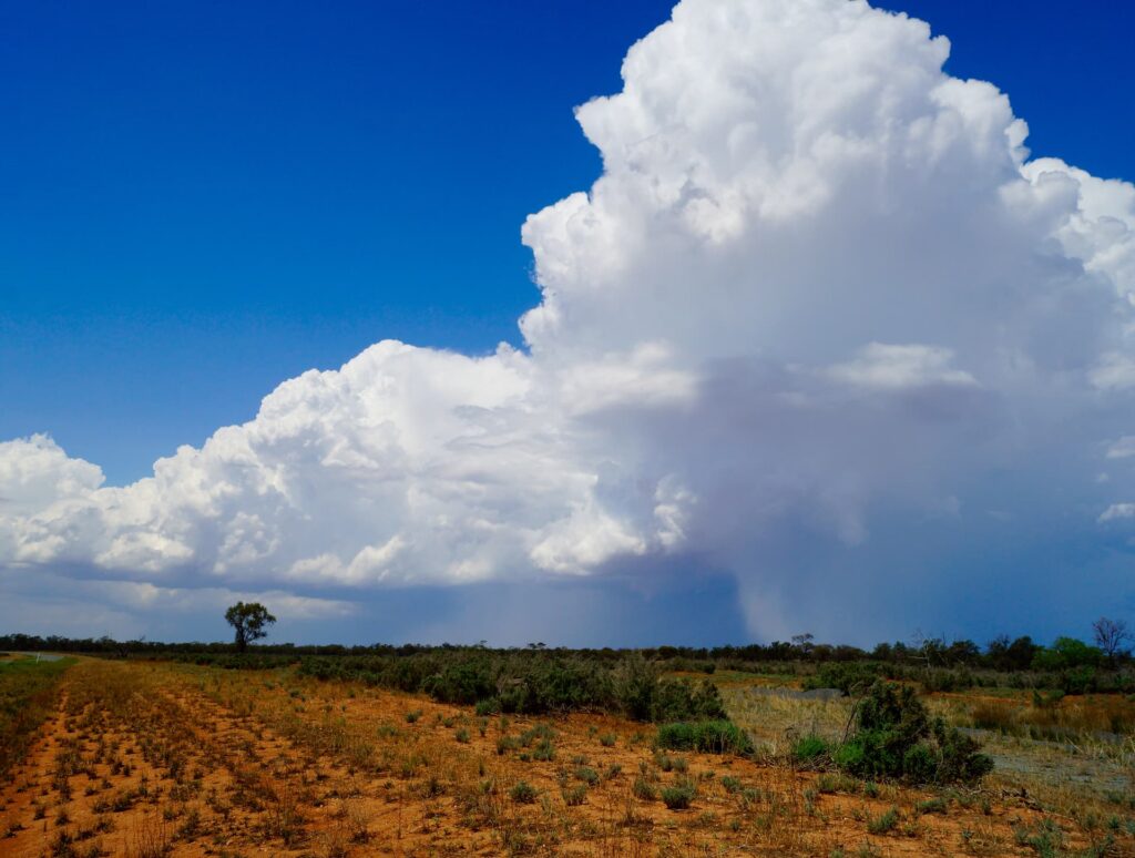 Landscape photo of the Australian outback with storm clouds on the horizon